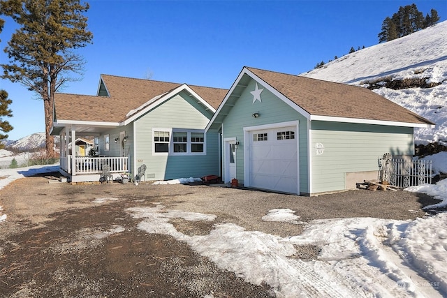 single story home with a garage and a porch