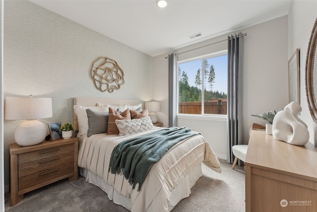 bedroom featuring dark carpet