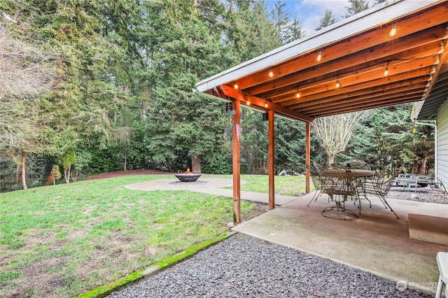 view of yard featuring a patio area and an outdoor fire pit