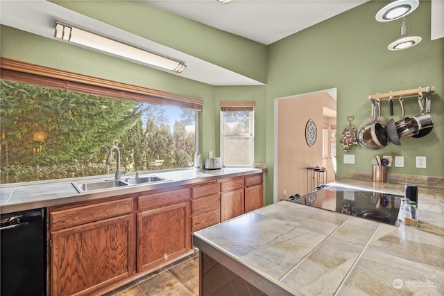 kitchen featuring sink, tile counters, and black appliances