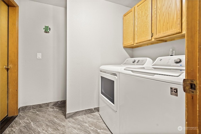 laundry area with cabinets and washing machine and clothes dryer