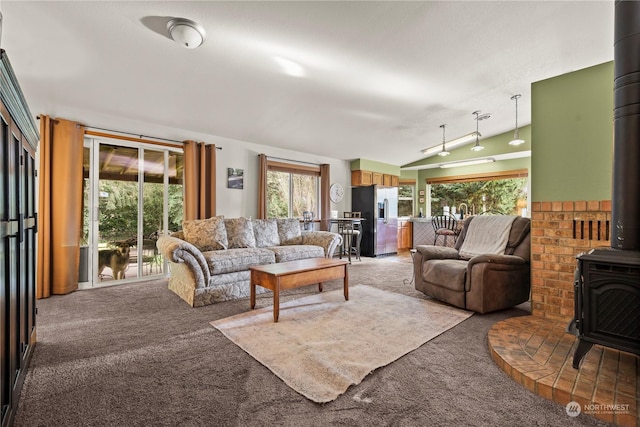 carpeted living room featuring a wood stove and track lighting