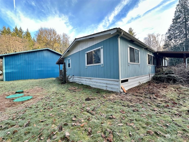 view of side of home with a lawn