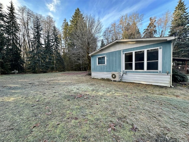 view of home's exterior with ac unit and a lawn