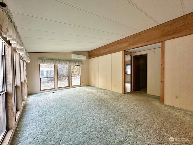 carpeted empty room featuring a wall unit AC