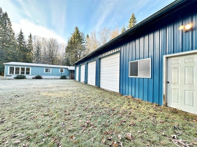 view of side of property featuring a yard