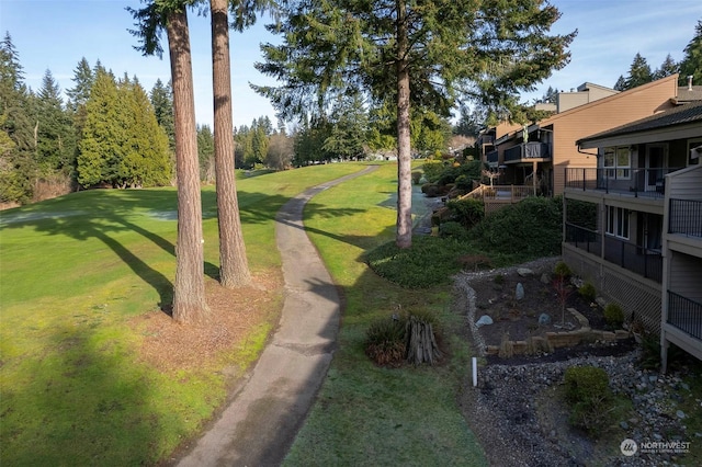 view of property's community featuring a yard