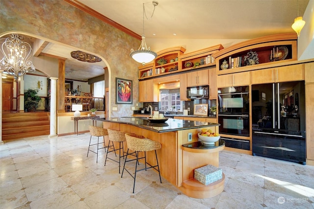 kitchen with pendant lighting, black appliances, a towering ceiling, a kitchen breakfast bar, and a notable chandelier