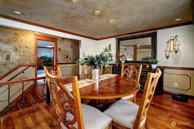 dining room with crown molding and wood-type flooring