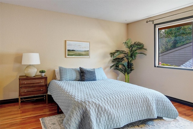 bedroom with wood-type flooring