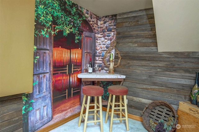 dining room with wood walls