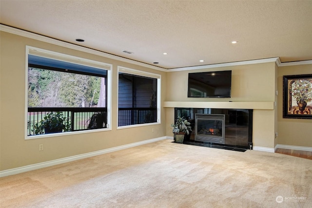 unfurnished living room featuring carpet floors, crown molding, and a tiled fireplace