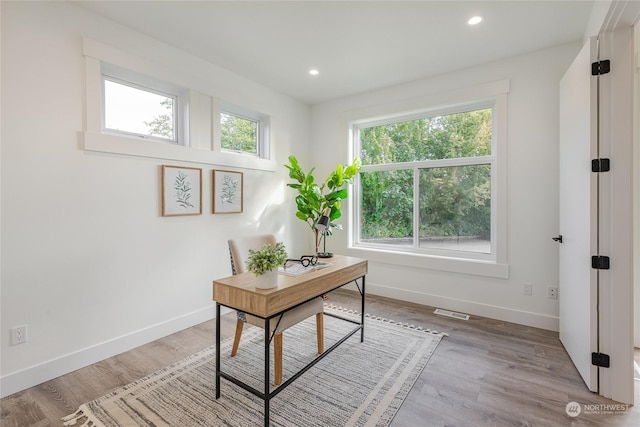 office space with light wood-type flooring