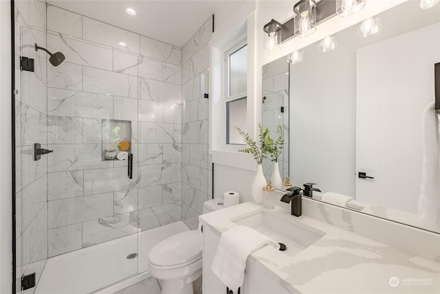 bathroom featuring vanity, toilet, and an enclosed shower