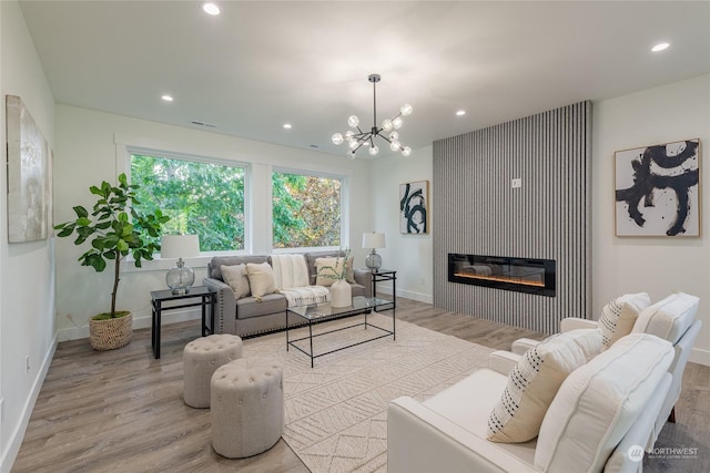 living room featuring a notable chandelier and light hardwood / wood-style flooring