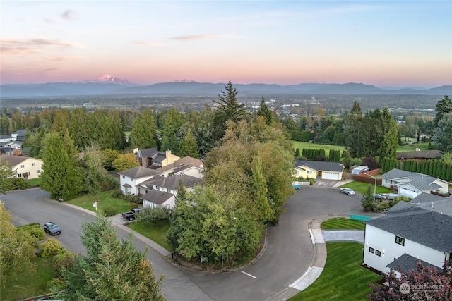 aerial view at dusk featuring a mountain view