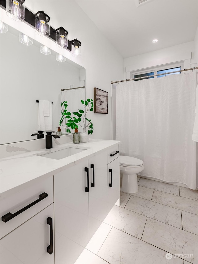 bathroom with vanity and toilet