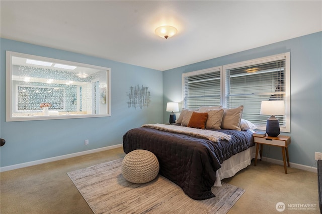 bedroom featuring light carpet, multiple windows, and baseboards