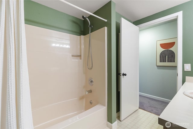 full bathroom with tile patterned floors, shower / bath combo with shower curtain, vanity, and baseboards