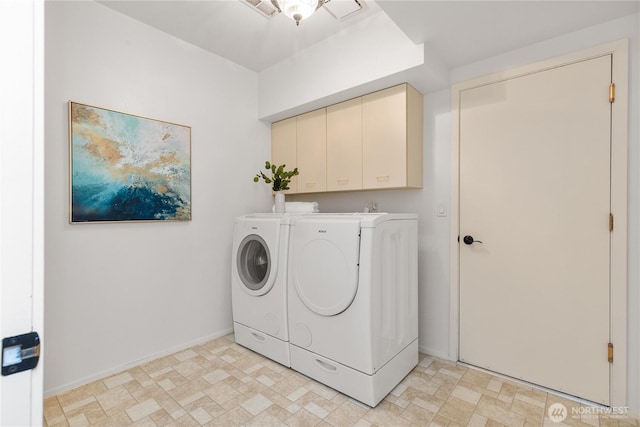 laundry area featuring cabinet space, baseboards, and washer and clothes dryer