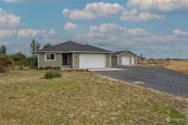 ranch-style home featuring a garage and a front lawn