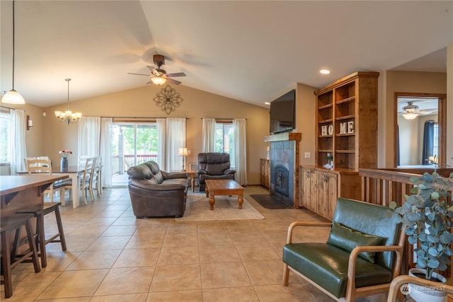 living room with light tile patterned floors, vaulted ceiling, a fireplace, and ceiling fan with notable chandelier