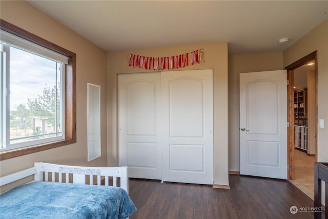 bedroom with a closet and dark hardwood / wood-style flooring