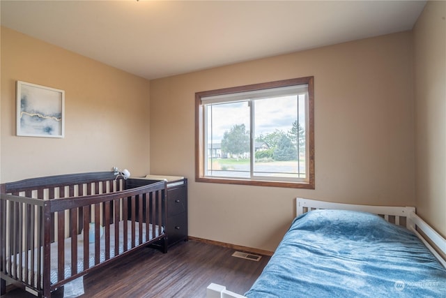 bedroom with dark wood-type flooring