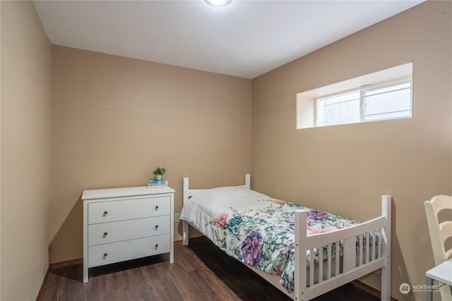 bedroom featuring dark hardwood / wood-style flooring