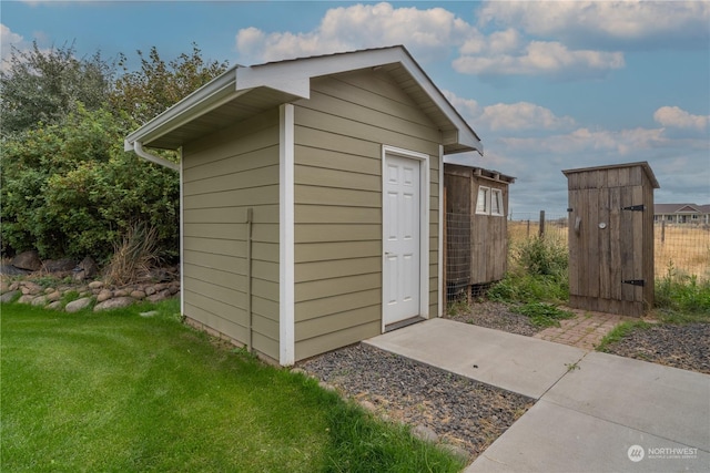 view of outbuilding with a lawn