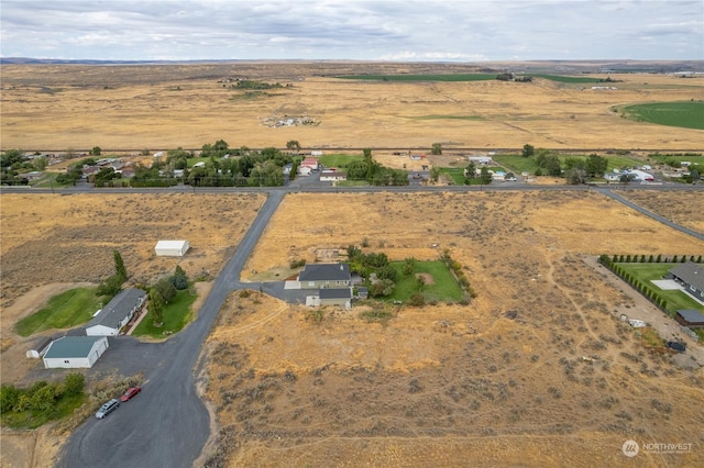 birds eye view of property with a rural view