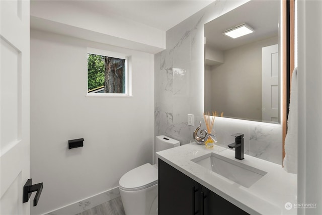 bathroom with vanity, hardwood / wood-style floors, and toilet