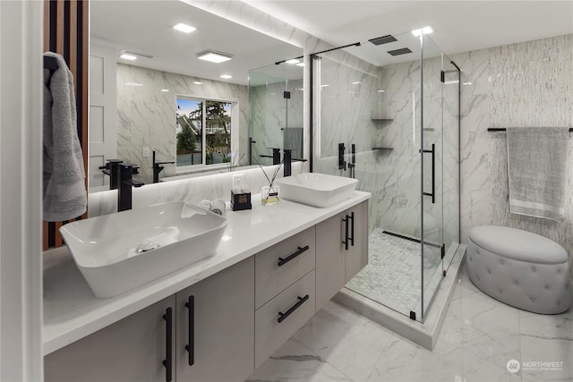 bathroom with vanity, tile walls, and walk in shower