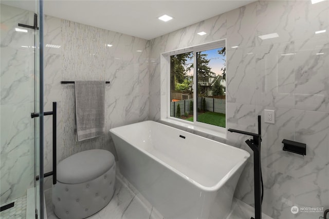 bathroom featuring a tub and tile walls