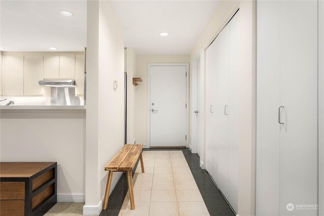 hall featuring light tile patterned floors