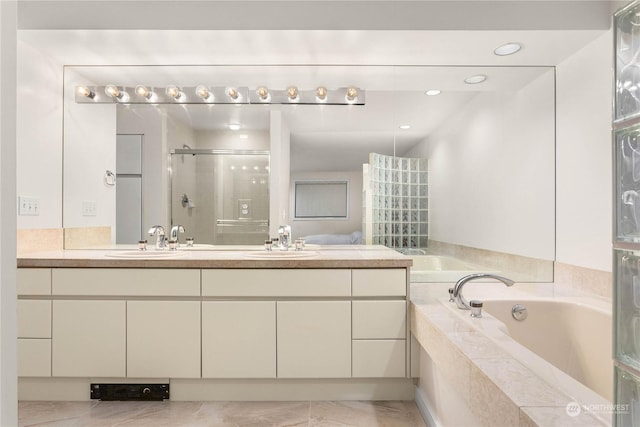 bathroom featuring independent shower and bath and vanity