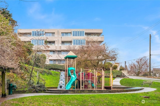 view of playground with a lawn