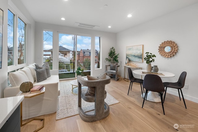 living room featuring light wood-type flooring and plenty of natural light