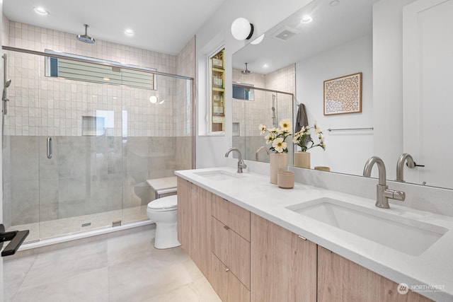 bathroom featuring toilet, walk in shower, and vanity