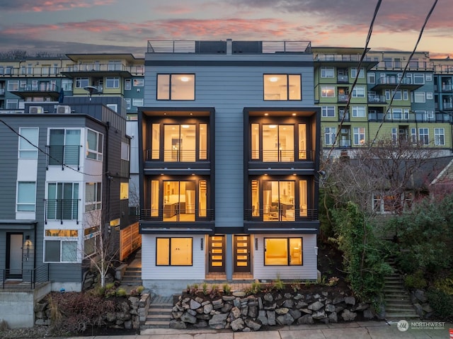 view of back house at dusk