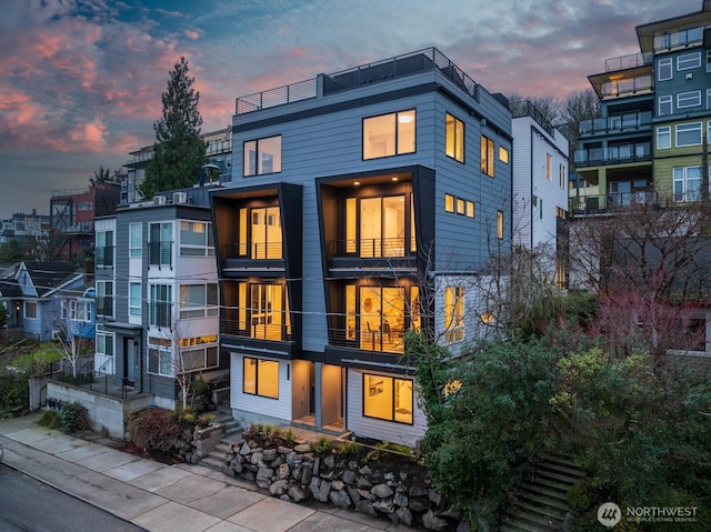 2011A Dexter Ave N, Seattle, WA 98109 - back of house at dusk featuring a balcony