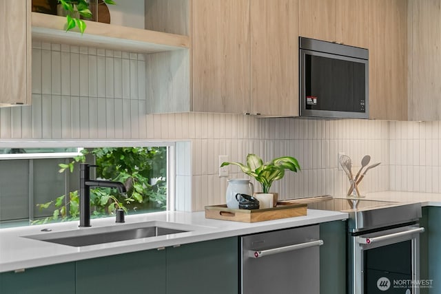 2011A Dexter Ave N, Seattle, WA 98109 - kitchen featuring appliances with stainless steel finishes, decorative backsplash, modern cabinets, and light countertops