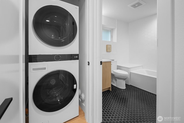 2011A Dexter Ave N, Seattle, WA 98109 - bathroom featuring estacked washer and dryer, vanity, and a bath