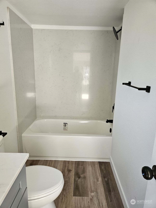 full bathroom with wood-type flooring, toilet, shower / bathing tub combination, and vanity