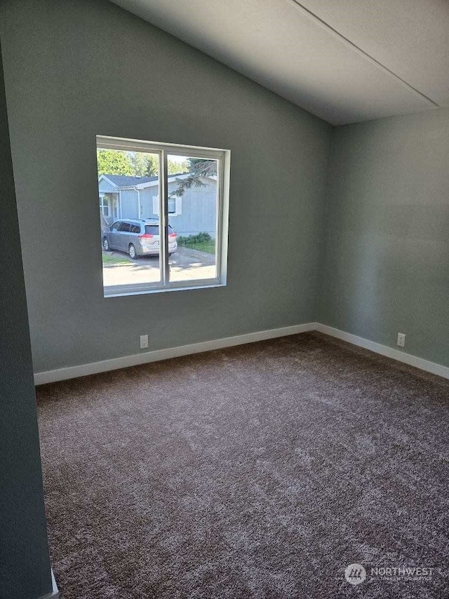 unfurnished room with carpet flooring and lofted ceiling