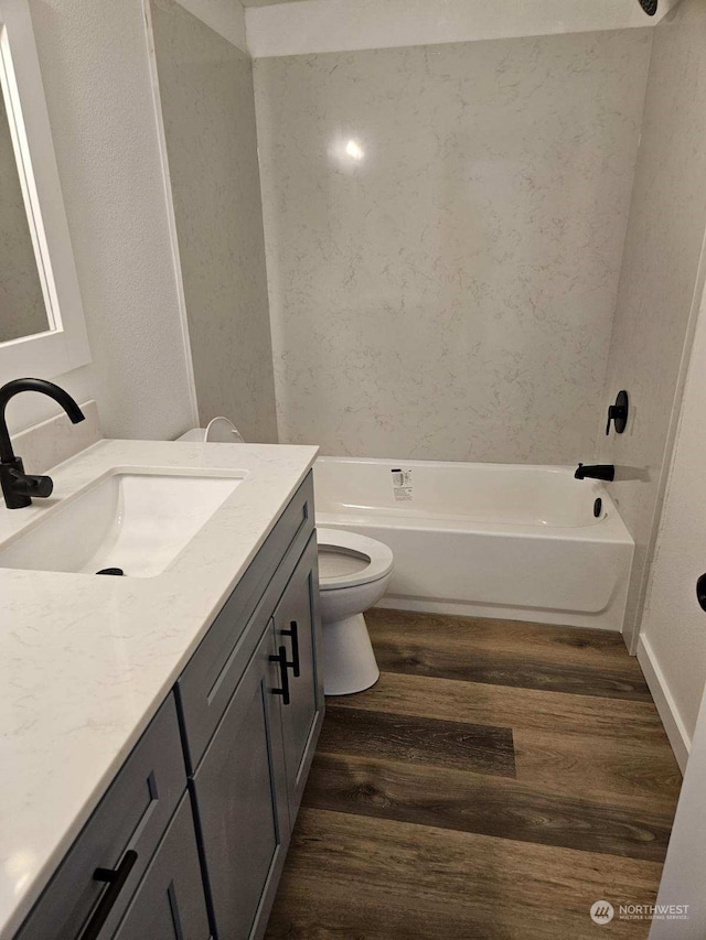 bathroom featuring hardwood / wood-style flooring, toilet, and vanity