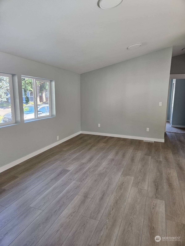 unfurnished room featuring hardwood / wood-style flooring