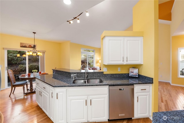 kitchen with decorative light fixtures, sink, white cabinetry, and stainless steel dishwasher