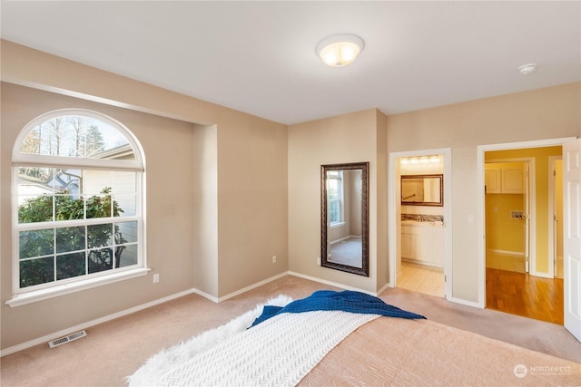 carpeted bedroom with ensuite bathroom