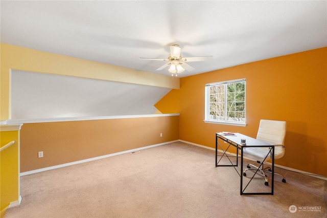 home office with ceiling fan, light colored carpet, and vaulted ceiling